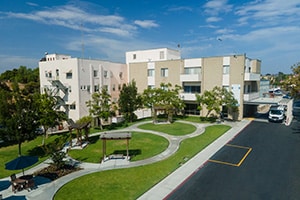 Courtyard, green grass, and sidewalks of the Paradise Valley Manor care center